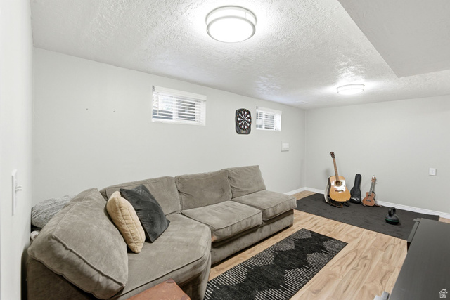 935 900 North Bountiful, UT 84010 - Photo 27 of 46 Living area featuring a textured ceiling and light wood finished floors