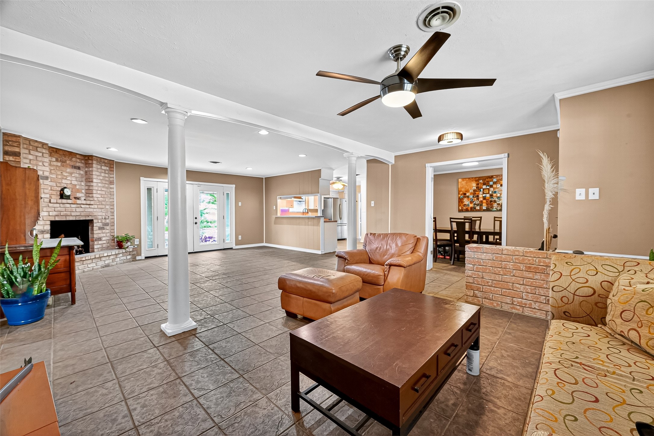 10302 Ivyridge Road Houston, TX 77043 - Photo 11 of 47 a living room with furniture a fireplace and a chandelier