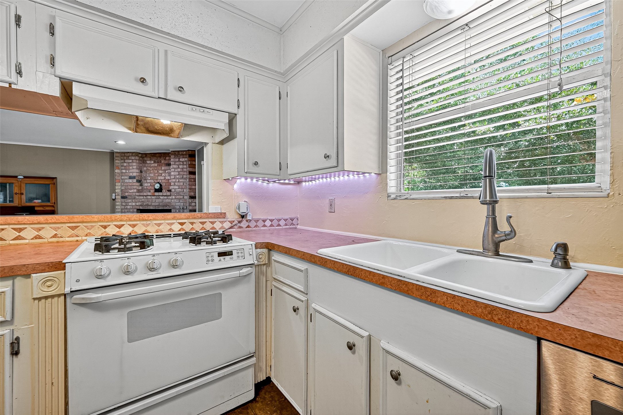 10302 Ivyridge Road Houston, TX 77043 - Photo 23 of 47 a kitchen with a sink stove and cabinets
