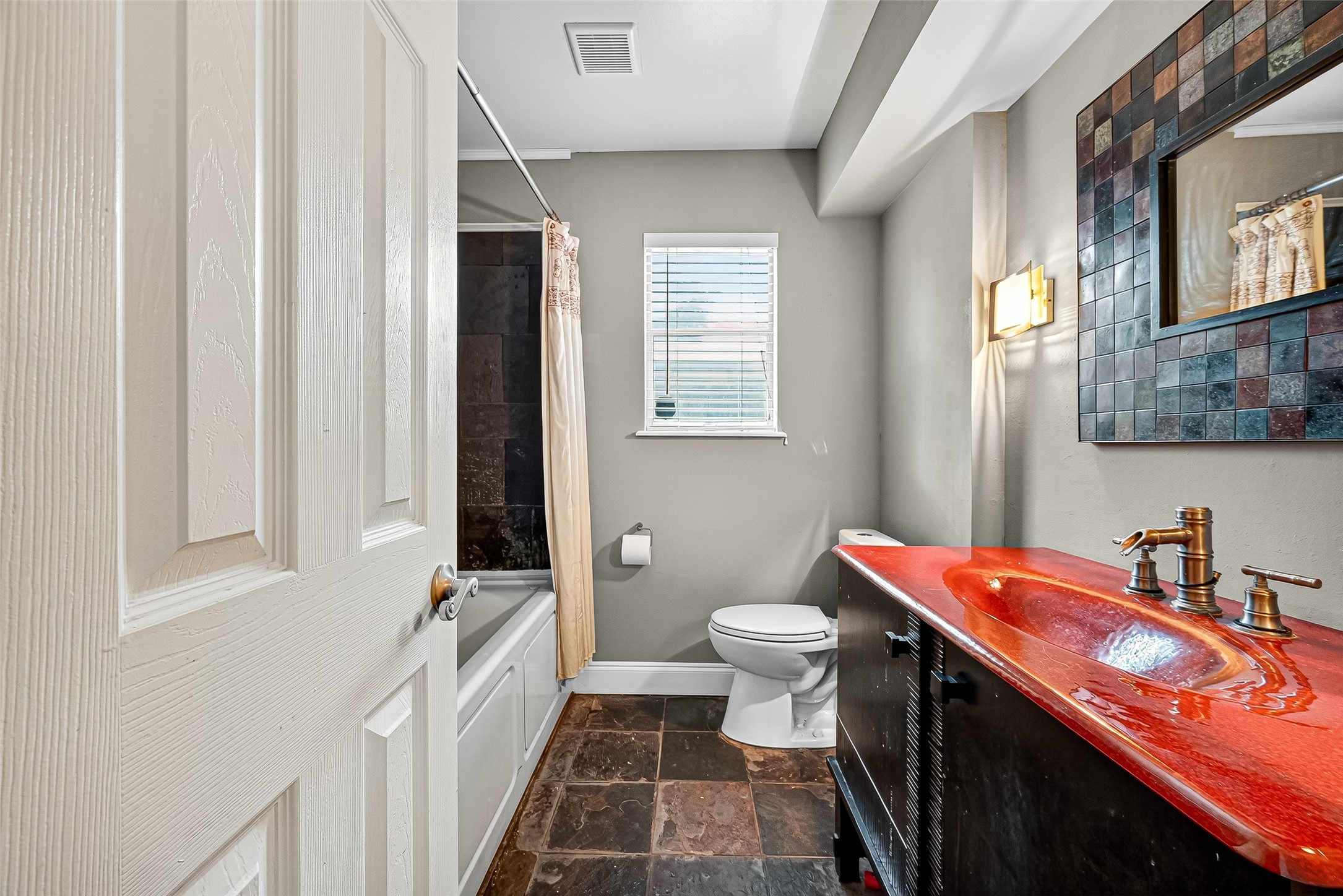 10302 Ivyridge Road Houston, TX 77043 - Photo 29 of 47 a bathroom with a sink a toilet and a mirror