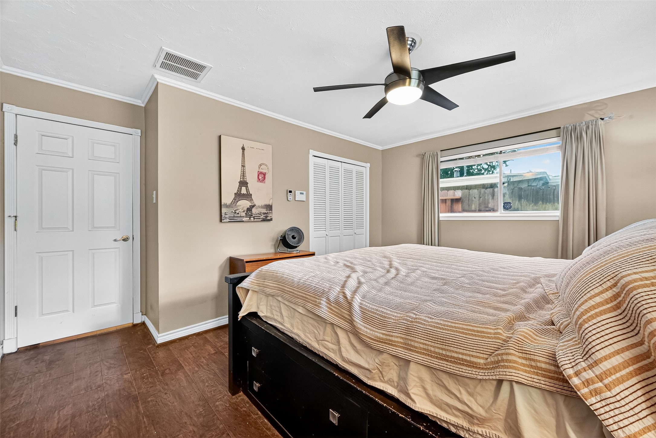 10302 Ivyridge Road Houston, TX 77043 - Photo 36 of 47 a bedroom with a bed and a chandelier