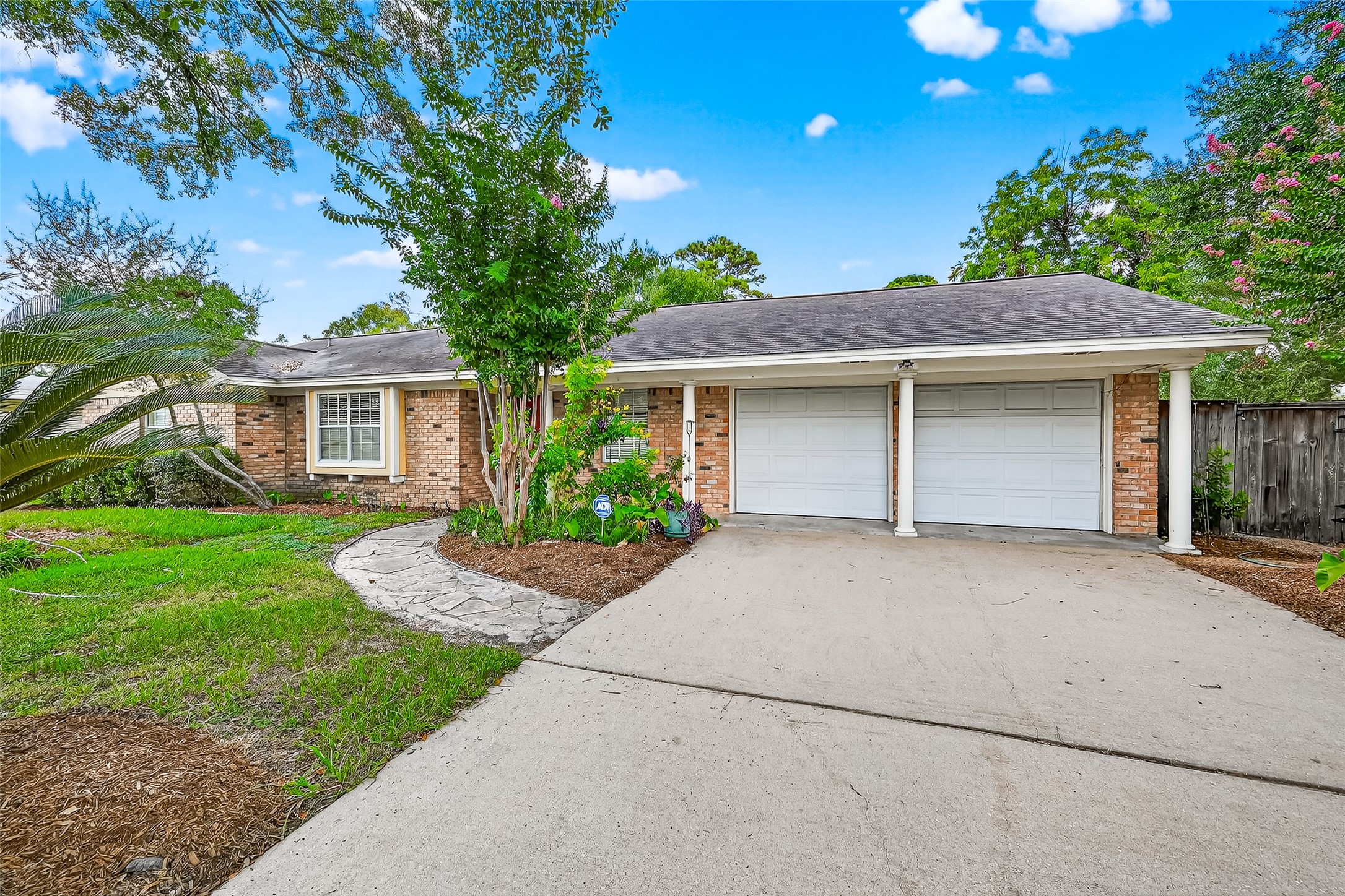 10302 Ivyridge Road Houston, TX 77043 - Photo 5 of 47 a front view of a house with a yard and garage