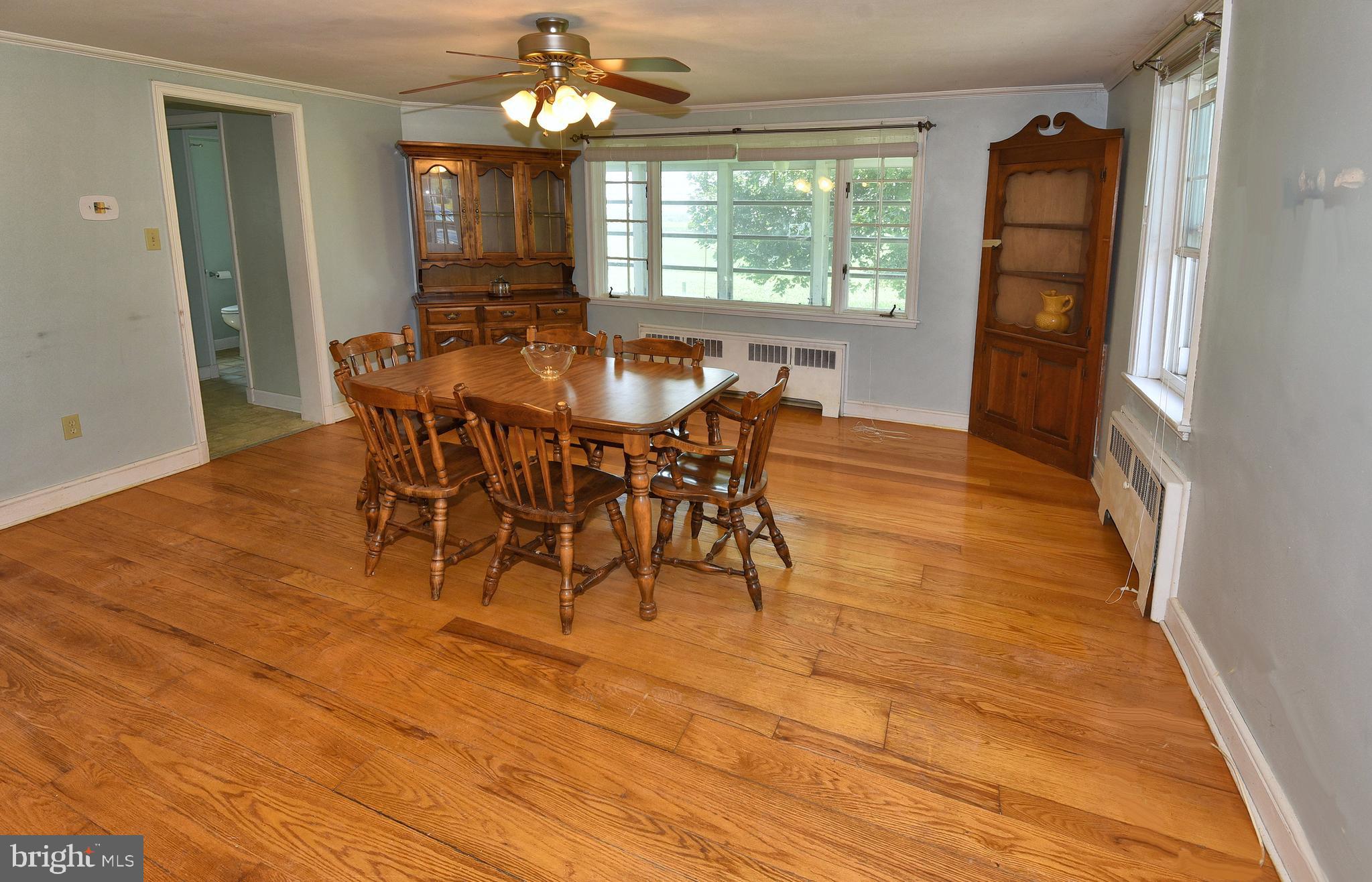126 South Clear Ridge Road New Windsor, MD 21776 - Photo 5 of 34 Large DR w/ Hdwoods & large window to side porch