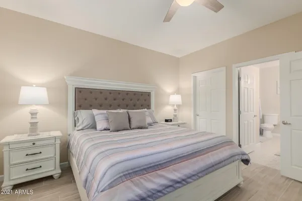 a bedroom with a bed and a night stand