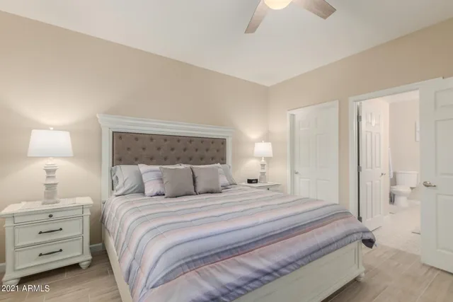 a bedroom with a bed and a night stand