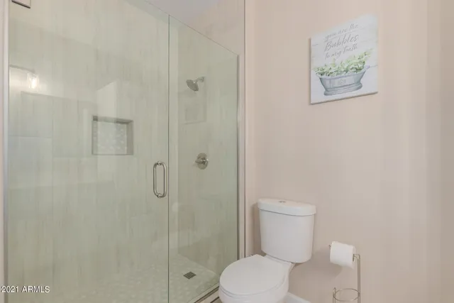 a white toilet sitting next to a bathroom