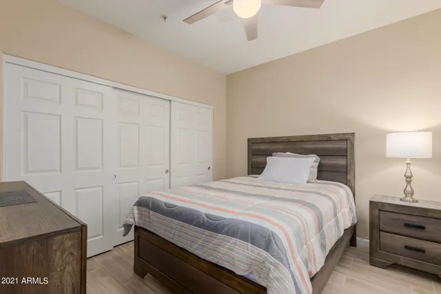 a bedroom with a bed and a night stand