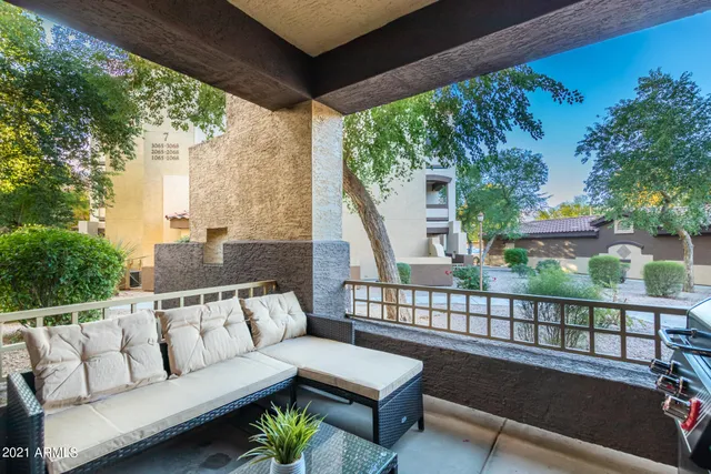 a roof deck with couches and wooden floor