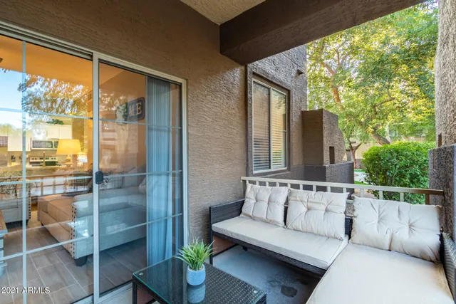 a balcony with furniture and a potted plant