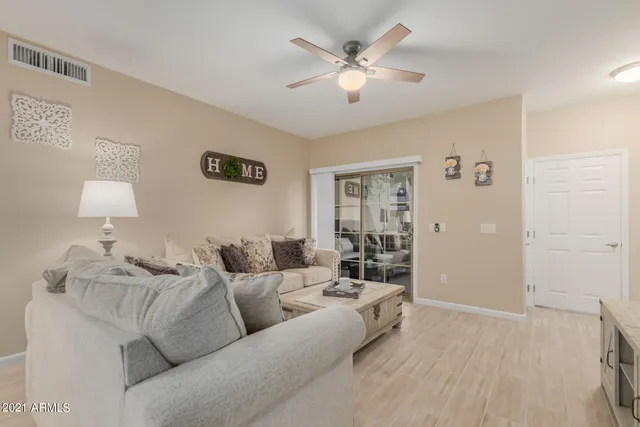 a living room with furniture and a lamp