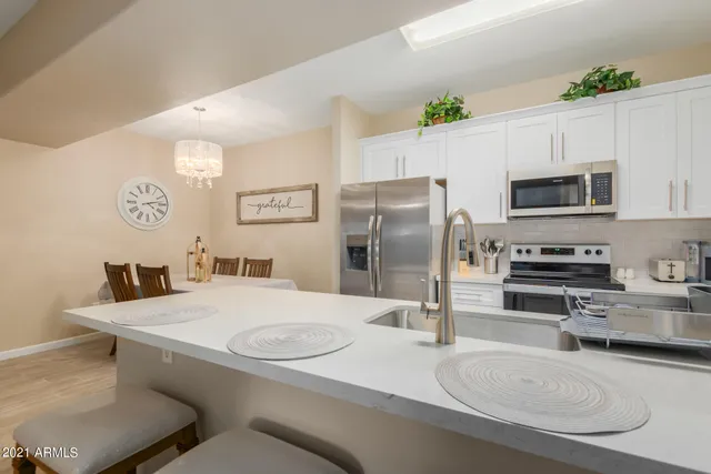 a kitchen with stainless steel appliances a refrigerator and a stove