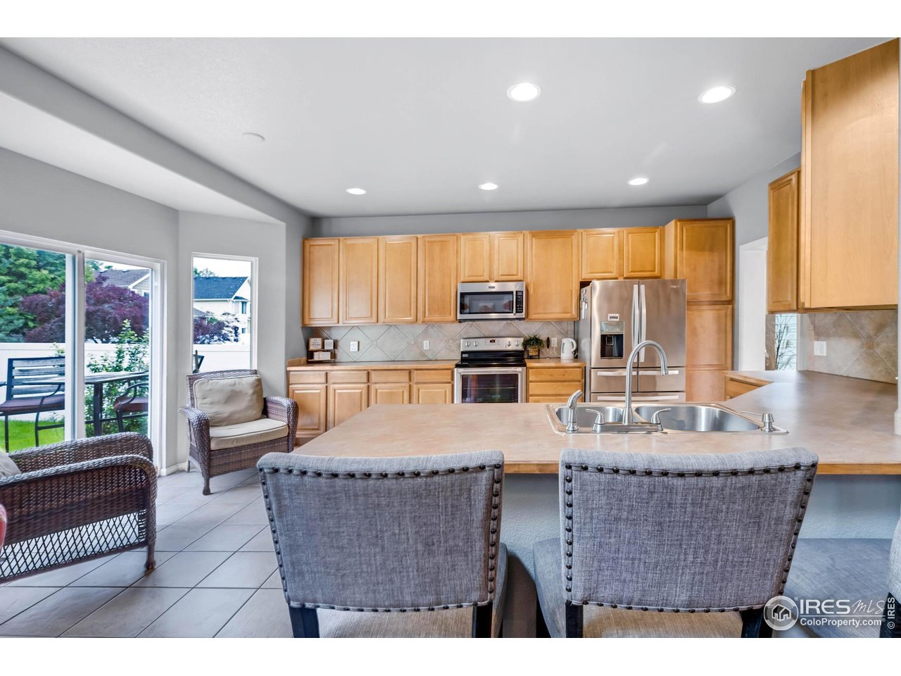 116 Cobble Court Windsor, CO 80550 - Photo 13 of 41 a living room with granite countertop furniture a large window