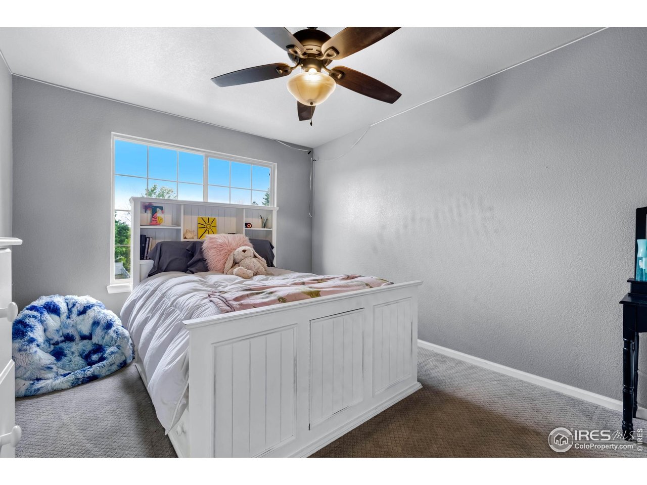 116 Cobble Court Windsor, CO 80550 - Photo 19 of 41 a bedroom with a bed and a chandelier