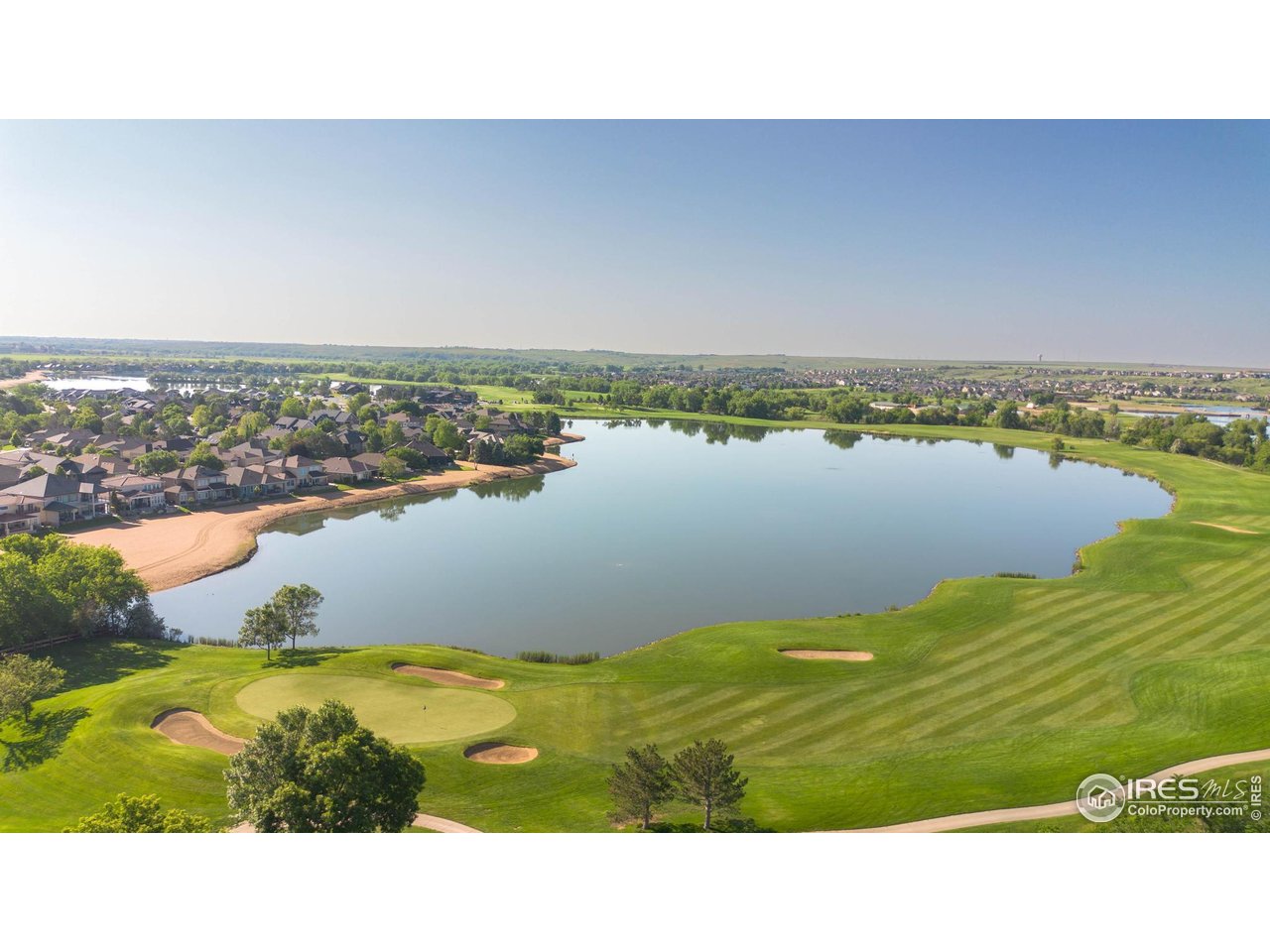 116 Cobble Court Windsor, CO 80550 - Photo 33 of 41 a view of a lake with houses in the back