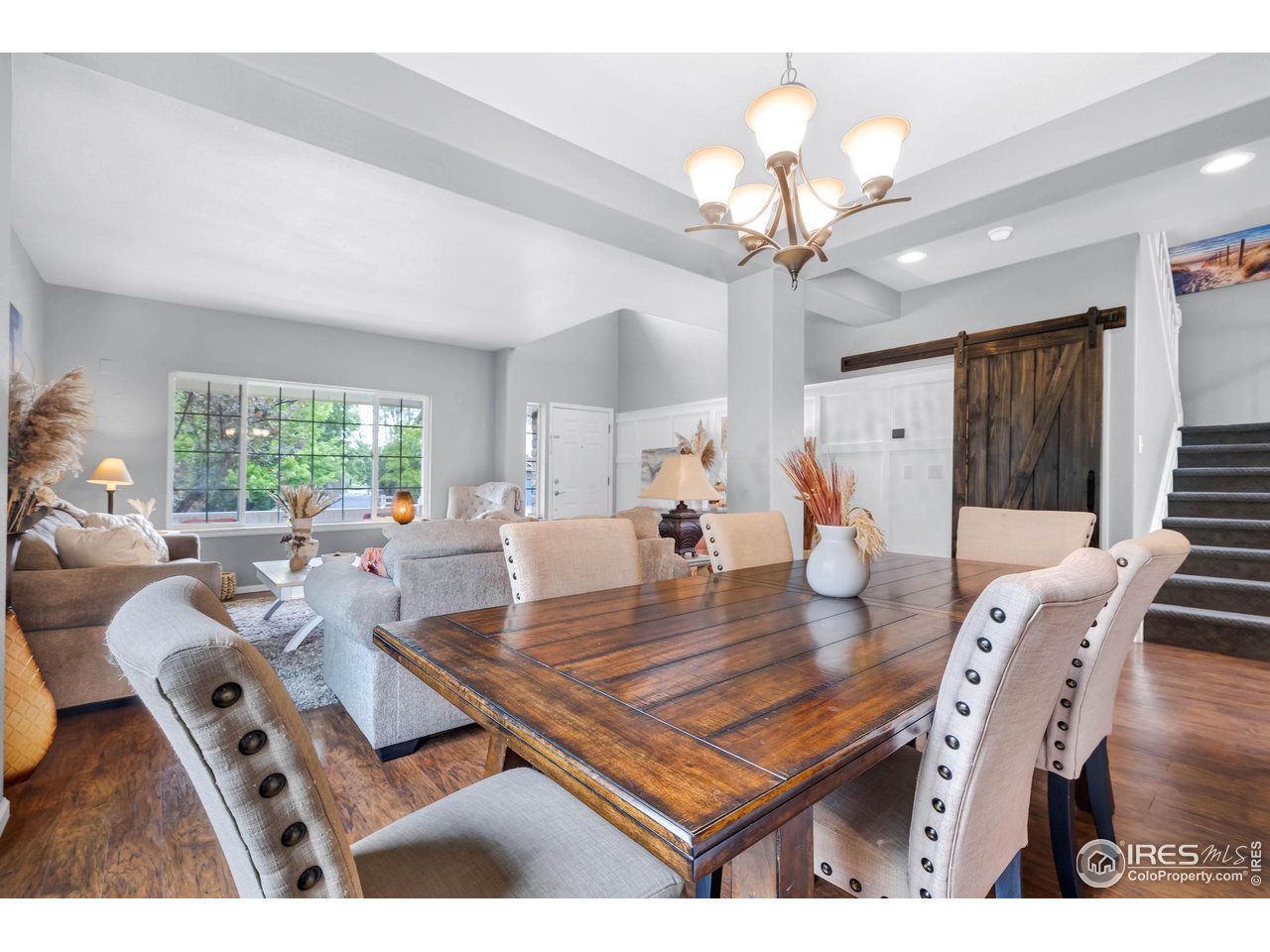 116 Cobble Court Windsor, CO 80550 - Photo 8 of 41 a living room with furniture a chandelier and a table