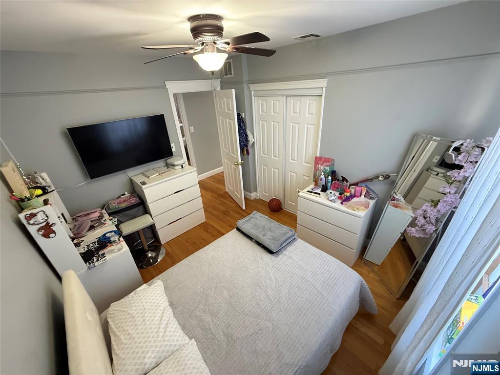 41 Stuyvesant Road Teaneck, NJ 07666 - Photo 12 of 21 a bedroom with a bed window and a flat screen tv