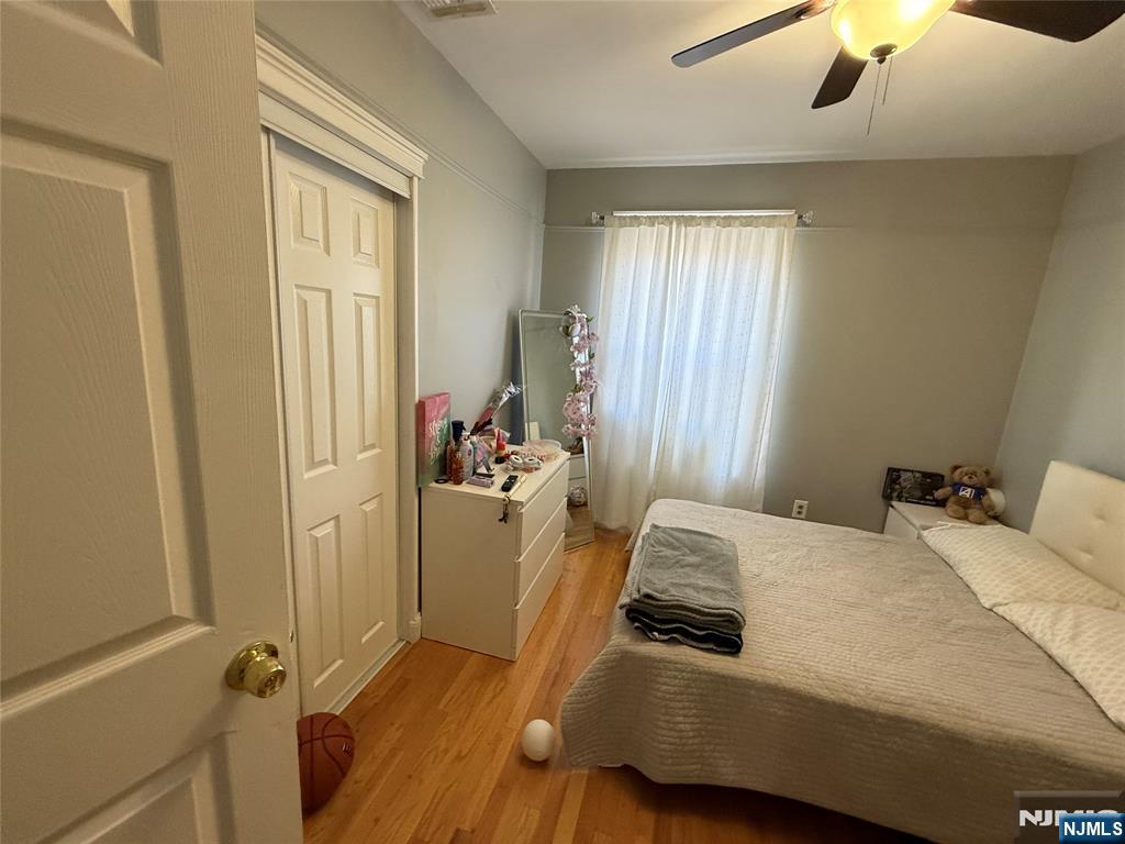 41 Stuyvesant Road Teaneck, NJ 07666 - Photo 13 of 21 a bedroom with a bed and wooden floor