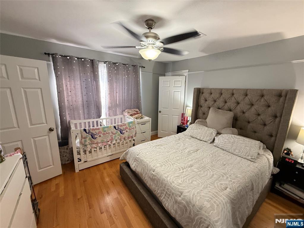41 Stuyvesant Road Teaneck, NJ 07666 - Photo 14 of 21 a bedroom with a bed and a chandelier