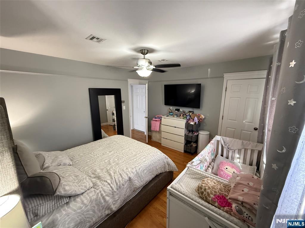 41 Stuyvesant Road Teaneck, NJ 07666 - Photo 15 of 21 a bedroom with a bed and a flat screen tv
