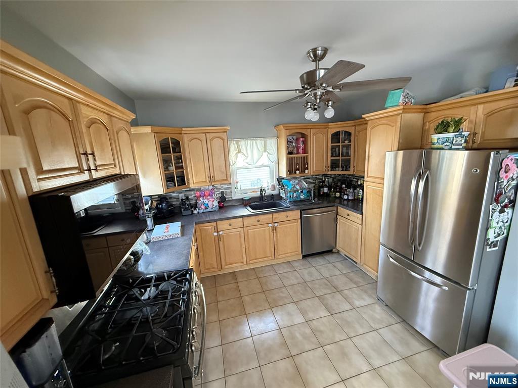 41 Stuyvesant Road Teaneck, NJ 07666 - Photo 4 of 21 a kitchen with a sink stainless steel appliances and a window