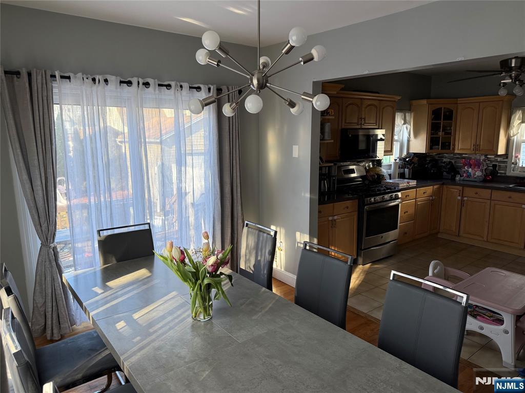 41 Stuyvesant Road Teaneck, NJ 07666 - Photo 7 of 21 a living room with furniture a fireplace and a chandelier