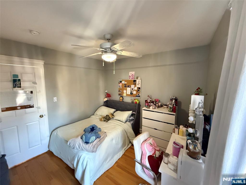 41 Stuyvesant Road Teaneck, NJ 07666 - Photo 9 of 21 a bedroom with furniture and a chandelier