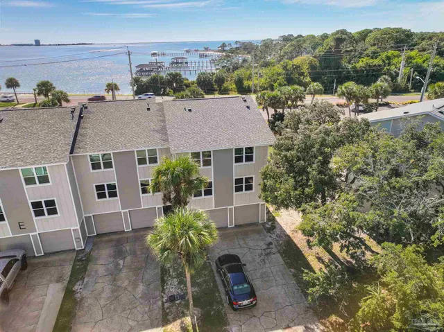 a swimming pool with outdoor seating and a yard