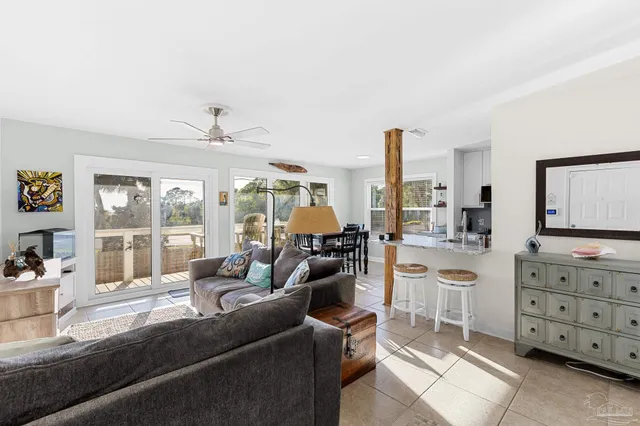 a living room with furniture and large windows
