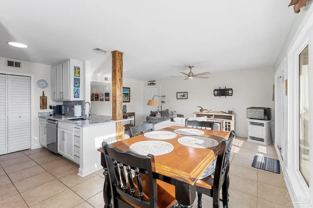 a large kitchen with a table and chairs