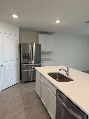 a kitchen with a sink cabinets and stainless steel appliances