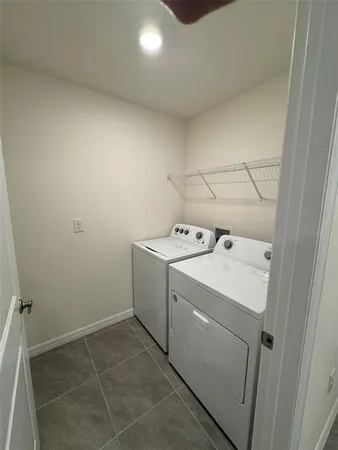 a view of a kitchen with a sink and a refrigerator