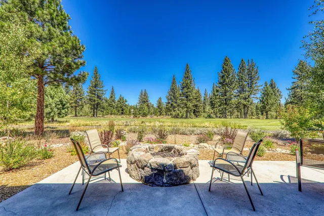 a view of a patio with dining table and chairs with wooden floor and fence