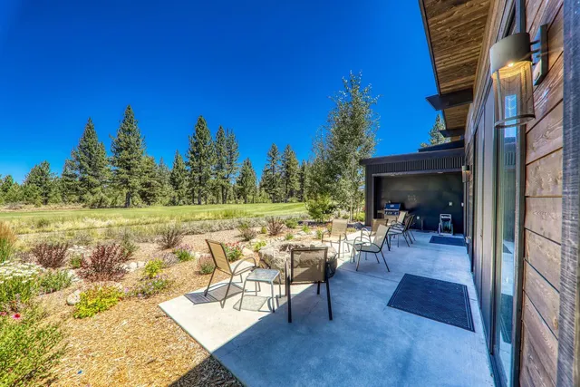 a view of a house with swimming pool and sitting area