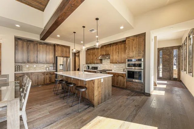 a living room with furniture fireplace and a large window