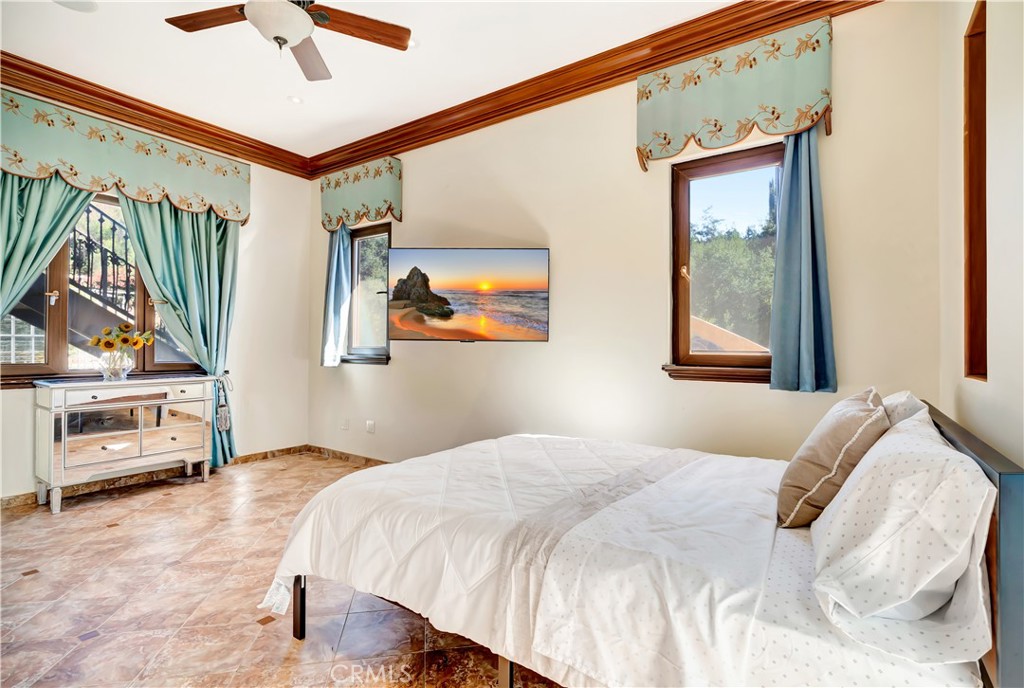 44 Hackamore Lane, Unit 46 Bell Canyon, CA 91307 - Photo 15 of 17 a bedroom with a bed and a painting on the wall