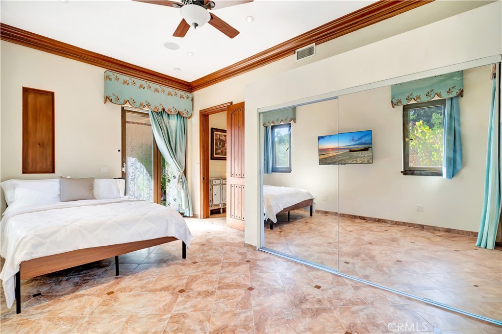 44 Hackamore Lane, Unit 46 Bell Canyon, CA 91307 - Photo 16 of 17 a bedroom with a bed a couch and a window