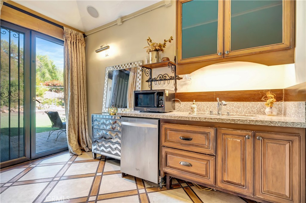 44 Hackamore Lane, Unit 46 Bell Canyon, CA 91307 - Photo 6 of 17 a spacious bathroom with a granite countertop sink and a mirror