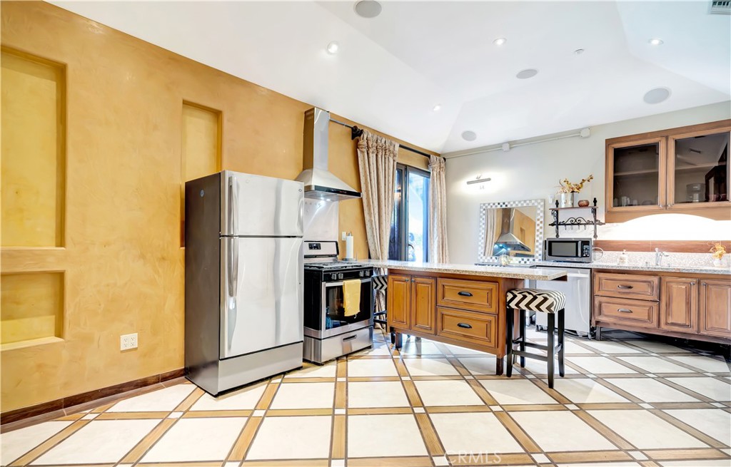 44 Hackamore Lane, Unit 46 Bell Canyon, CA 91307 - Photo 9 of 17 a kitchen with stainless steel appliances granite countertop a refrigerator and a stove top oven