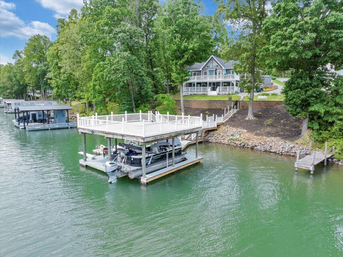 244 Cove Road Penhook, VA 24137 - Photo 1 of 88 a view of a lake with a big yard and large trees