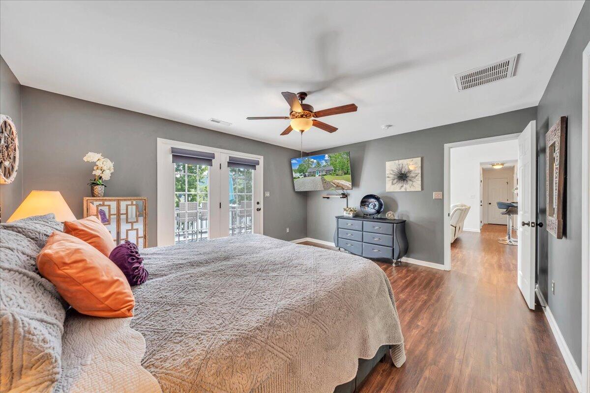 244 Cove Road Penhook, VA 24137 - Photo 21 of 88 a bedroom with a bed and a chandelier