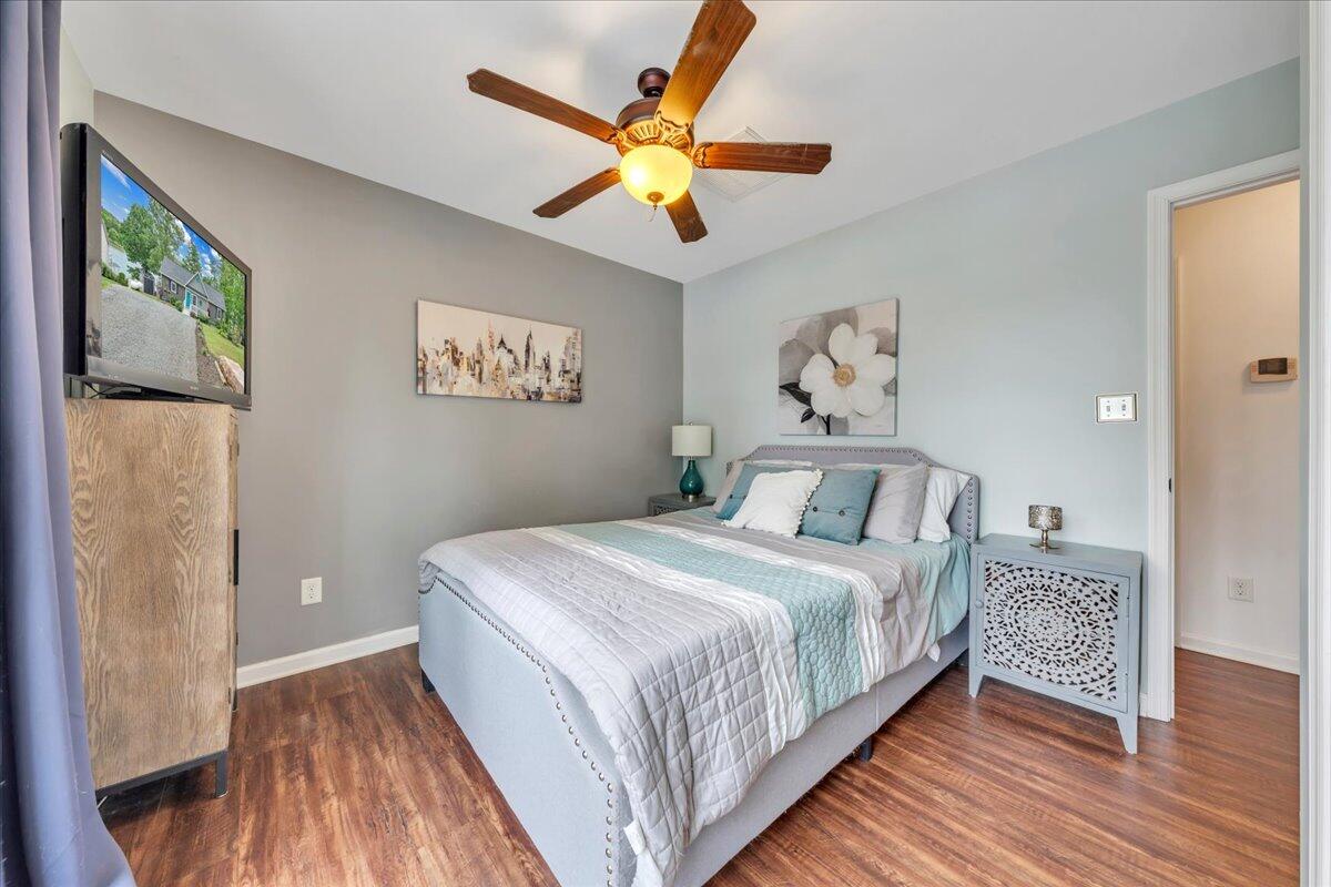 244 Cove Road Penhook, VA 24137 - Photo 27 of 88 a bedroom with a large bed and a chandelier