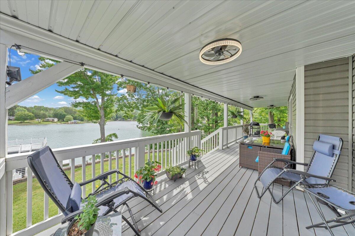244 Cove Road Penhook, VA 24137 - Photo 54 of 88 a view of a balcony with chairs and wooden floor