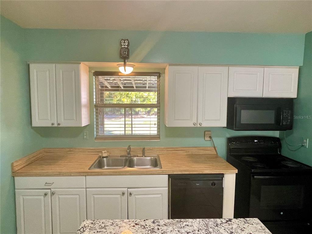 2043 Cordes Street Osprey, FL 34229 - Photo 11 of 35 a kitchen with a sink a stove and cabinets