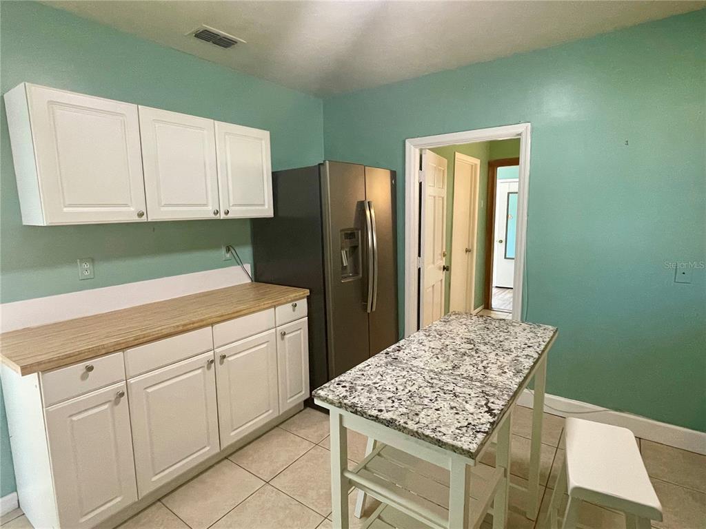 2043 Cordes Street Osprey, FL 34229 - Photo 12 of 35 a kitchen with cabinets and wooden floor