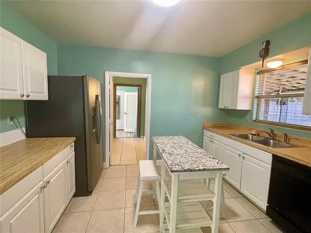 a kitchen with a sink cabinets and wooden floor