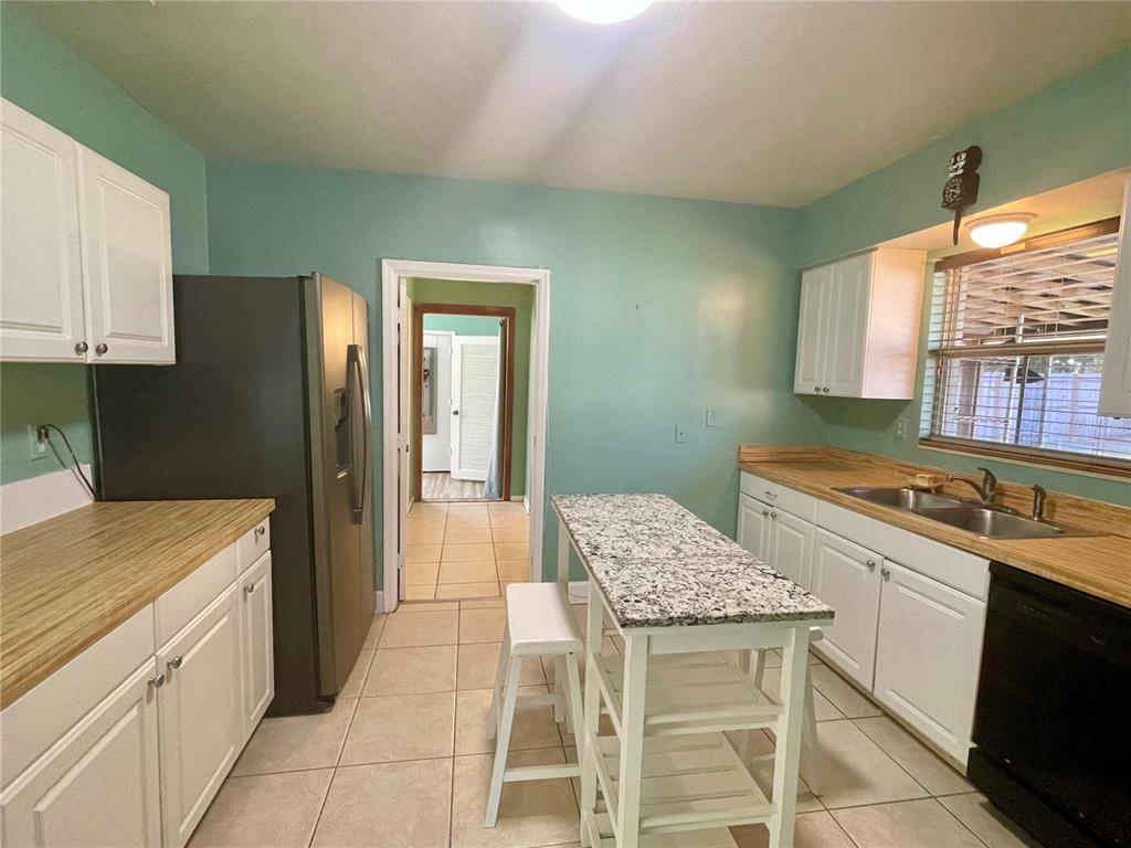 2043 Cordes Street Osprey, FL 34229 - Photo 13 of 35 a kitchen with a sink cabinets and wooden floor