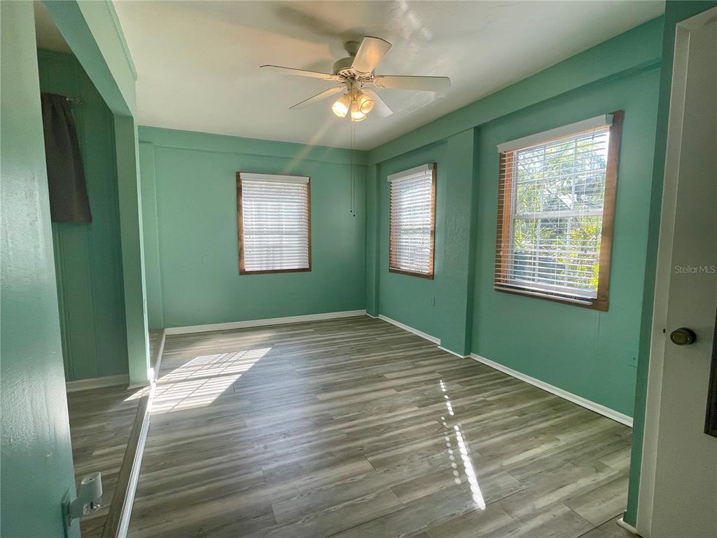 2043 Cordes Street Osprey, FL 34229 - Photo 16 of 35 a view of an empty room with a window and a chandelier fan