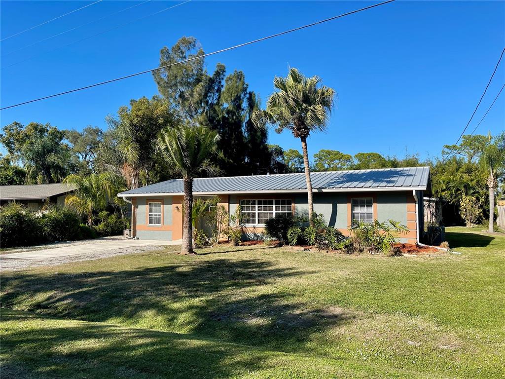 2043 Cordes Street Osprey, FL 34229 - Photo 2 of 35 a front view of a house with garden