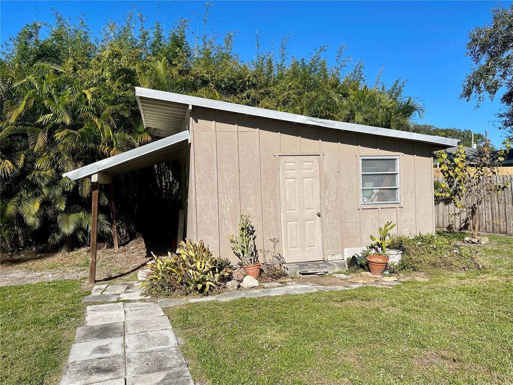 2043 Cordes Street Osprey, FL 34229 - Photo 31 of 35 a backyard of a house with potted plants and trees