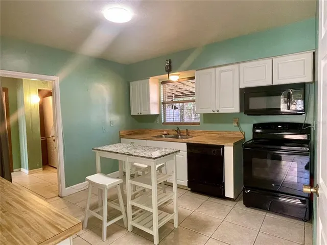 a kitchen with a stove a sink and a microwave